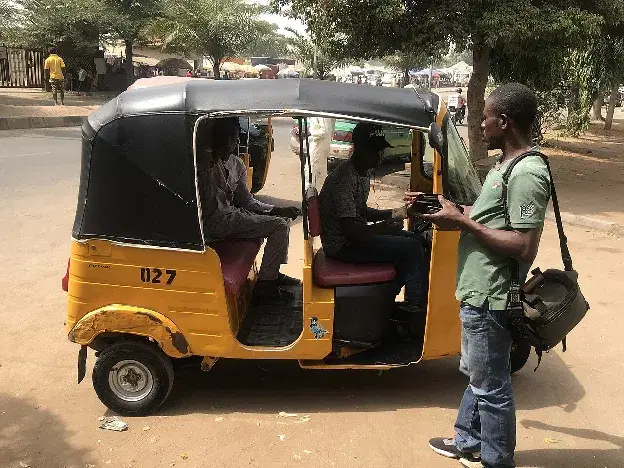 A passenger handing over a fare
